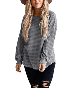 Detail showing grey waffle knit texture and loose puff sleeve on casual round neck sweater