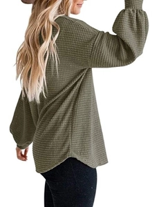 Detail of army green waffle knit long sleeve top with lantern sleeves and curved hem