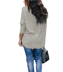 Detail view of women's light grey waffle knit long sleeve top with curved hem and loose fit