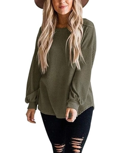 Detail shot of olive green waffle knit fabric and loose lantern sleeves on casual top