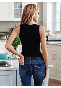 Close-up of the black sleeveless knitted vest showing the tight fit and minimalist back design