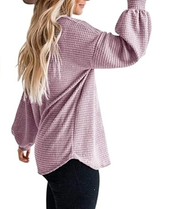 Close-up of lavender waffle knit texture and lantern sleeves with elastic cuffs on a top