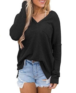 Detail of waffle-textured V-neck long sleeve top for women with side slit hem in black