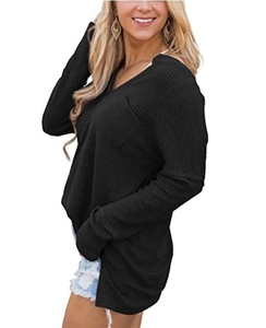 Close-up of black waffle knit V-neck top showing textured fabric and side slit details