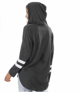 Detail view showing dark grey hooded sweatshirt with white sleeve stripes and curved back hem
