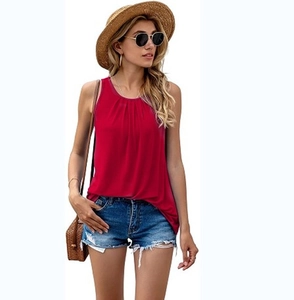 Detail of red sleeveless summer top showing pleated crew neck and lightweight chiffon fabric