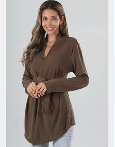 Detail showing the textured knit fabric and tie-waist closure of this brown long sleeve cardigan