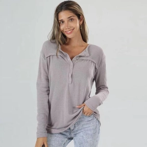 Close-up of the waffle knit texture and buttoned V-neckline on the lavender henley top