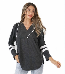 Detail view of dark grey hoodie with white sleeve stripes and drawstring neck