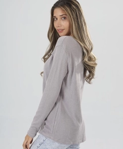 Detail shot of grey purple waffle knit top showing texture and relaxed sleeve fit