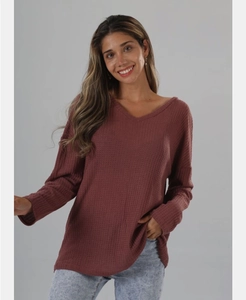 Detail of dusty rose V-neck waffle knit sweater featuring soft drop shoulder seams