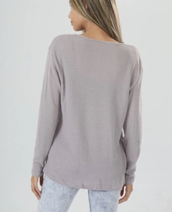 Back view of a casual waffle knit long sleeve top in lilac with relaxed fit and curved hem