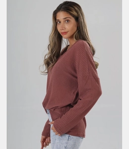Close-up of pink waffle knit texture and V-neck detail on casual oversized women's top