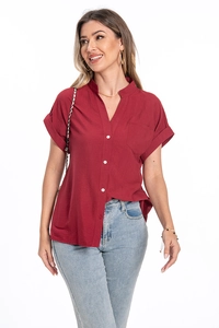 Detail of red short-sleeve cotton linen shirt with white buttons and a chest pocket