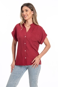 Detail of dark red cotton linen shirt featuring V-neckline, white buttons and chest pocket