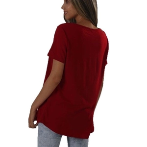 Back side view of a loose red short sleeve T-shirt paired with light blue jeans