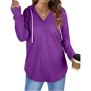 Detail of purple V-neck hoodie with white drawstring and curved hem on model