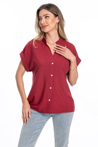 Detail view of burgundy cotton linen shirt showing textured fabric and front pocket