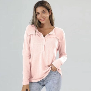 Women's light pink waffle knit long sleeve top with crew neck and button detail