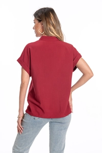 Detail view of burgundy cotton linen shirt with drop shoulder and rolled cuffs