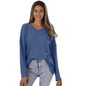 Blue V-neck waffle knit long sleeve top for women paired with light wash denim jeans