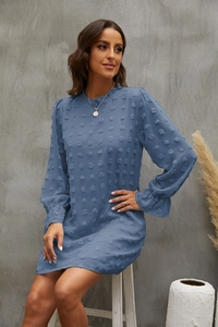 Detail of blue Swiss dot chiffon dress with long puff sleeves and textured fabric