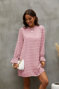 Detailed view of pink long sleeve mini dress with bubble texture and elastic ruffle cuffs