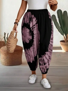 Detail of bohemian floral print on loose yoga pants with elasticated waist and ankle cuffs