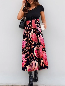 Detail of elegant V-neck patchwork maxi dress with vibrant pink tropical floral print
