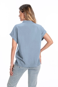 Detail of blue-gray short-sleeved cotton linen shirt with turn-down collar and rolled cuffs