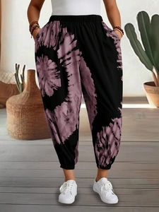 Detail of bohemian purple floral print pants with elastic waist and side pockets