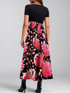 Rear view detail of a chic patchwork maxi dress featuring elegant floral patterns