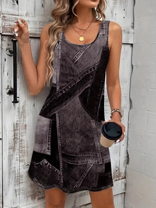 Close-up of a sleeveless A-line dress with vintage grey denim patchwork print and crew neck
