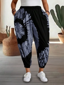 Detailed view of women tie-dye harem pants with elastic high waist and side pockets