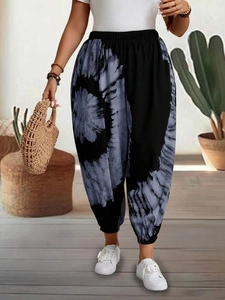 Close-up of the elastic high waistband on women's loose tie-dye harem jogger pants