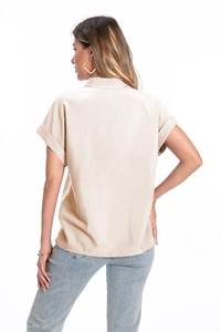 Rear view of a beige short-sleeve collared shirt showing clean back cut and seam details
