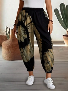 Detail of bohemian tie-dye harem pants with elastic waist and cuffed ankles for women