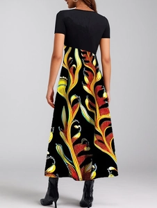 Back view of elegant maxi dress with black bodice and vibrant feather print skirt