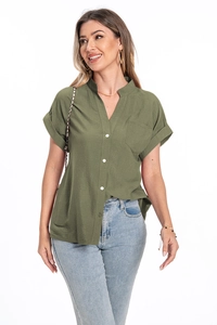 Detail view of olive green cotton linen shirt featuring white buttons and chest pocket