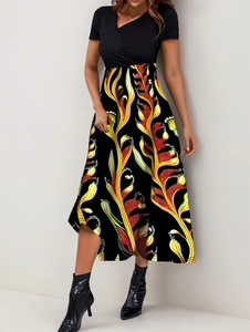 Detail of elegant V-neck patchwork dress with vibrant abstract leaf print and black top