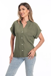 Detail of olive green linen shirt showing lapel collar, buttons and chest pocket