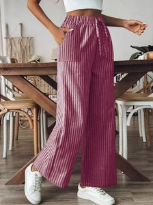 Detail of high waist striped wide leg trousers with drawstring and side pockets