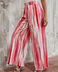 Detail view of high-waist wide-leg pants with colorful gradient vertical stripes and pleats