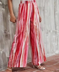 Detail of high-waisted wide-leg pants featuring vibrant vertical stripe patterns