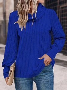 Dettaglio del maglione a dolcevita blu reale con trama in maglia a coste e maniche lunghe