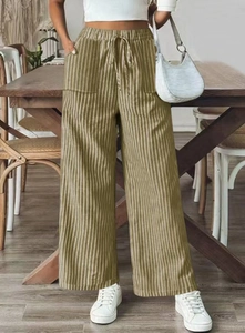 Detail of high waisted striped wide leg pants featuring drawstring waist and pockets