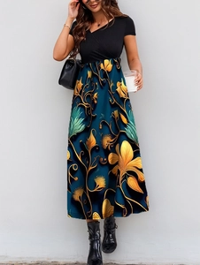 Detail of elegant V-neck patchwork dress featuring floral print and high waist line