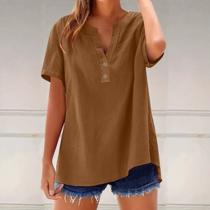 Detail of brown linen cotton blouse with V-neckline and decorative wooden buttons
