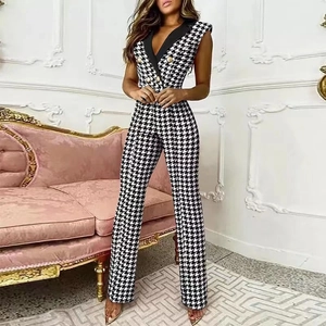 Detail of V-neck sleeveless houndstooth jumpsuit with golden buttons and wide leg design