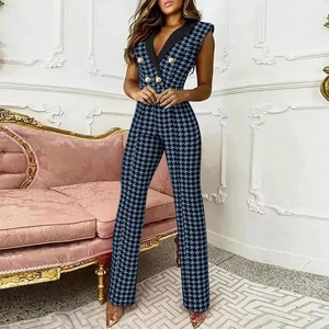 Detailed view of the blue houndstooth jumpsuit featuring elegant gold double-breasted buttons